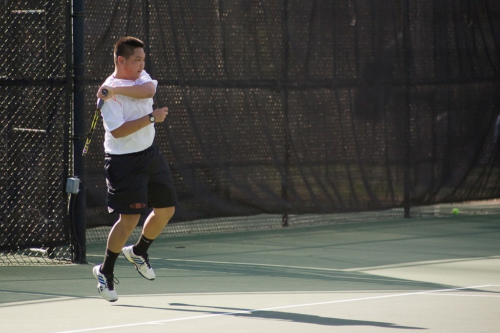 Mark Yee finishing his forehand.