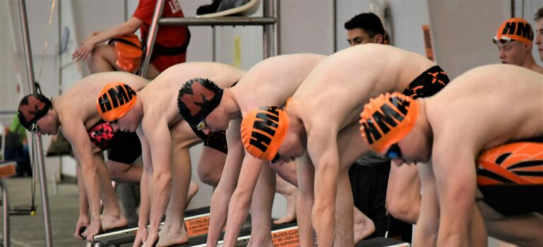Swimmers on the starting blocks.
