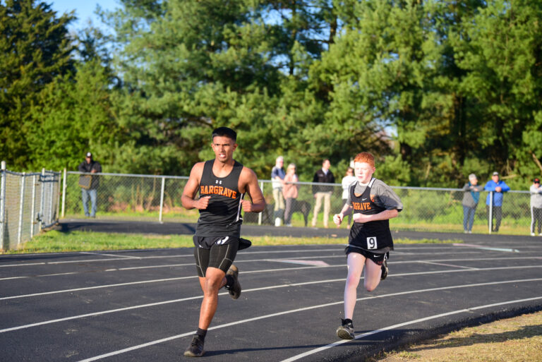 Two cadets running on a track.