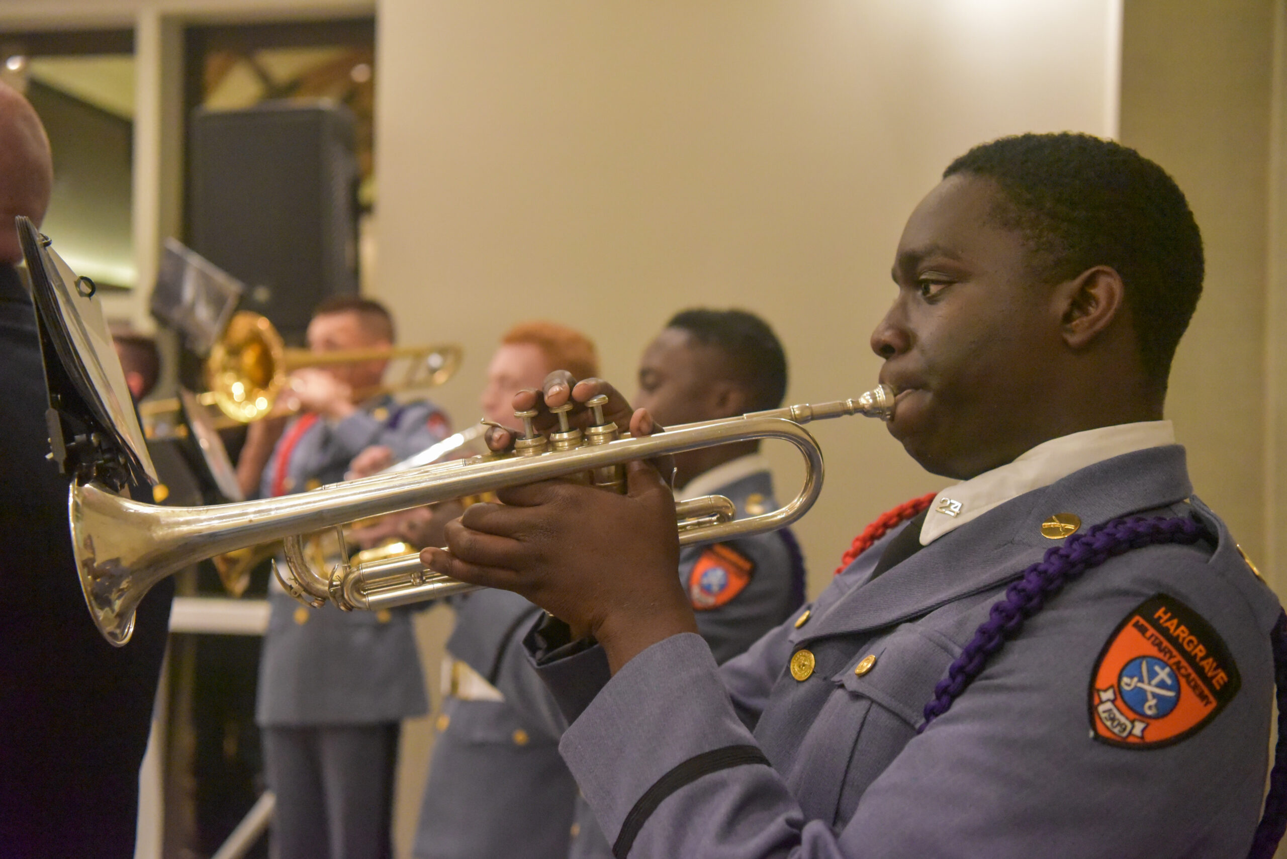 Close up of cadet playing trumpet at donor banquet.