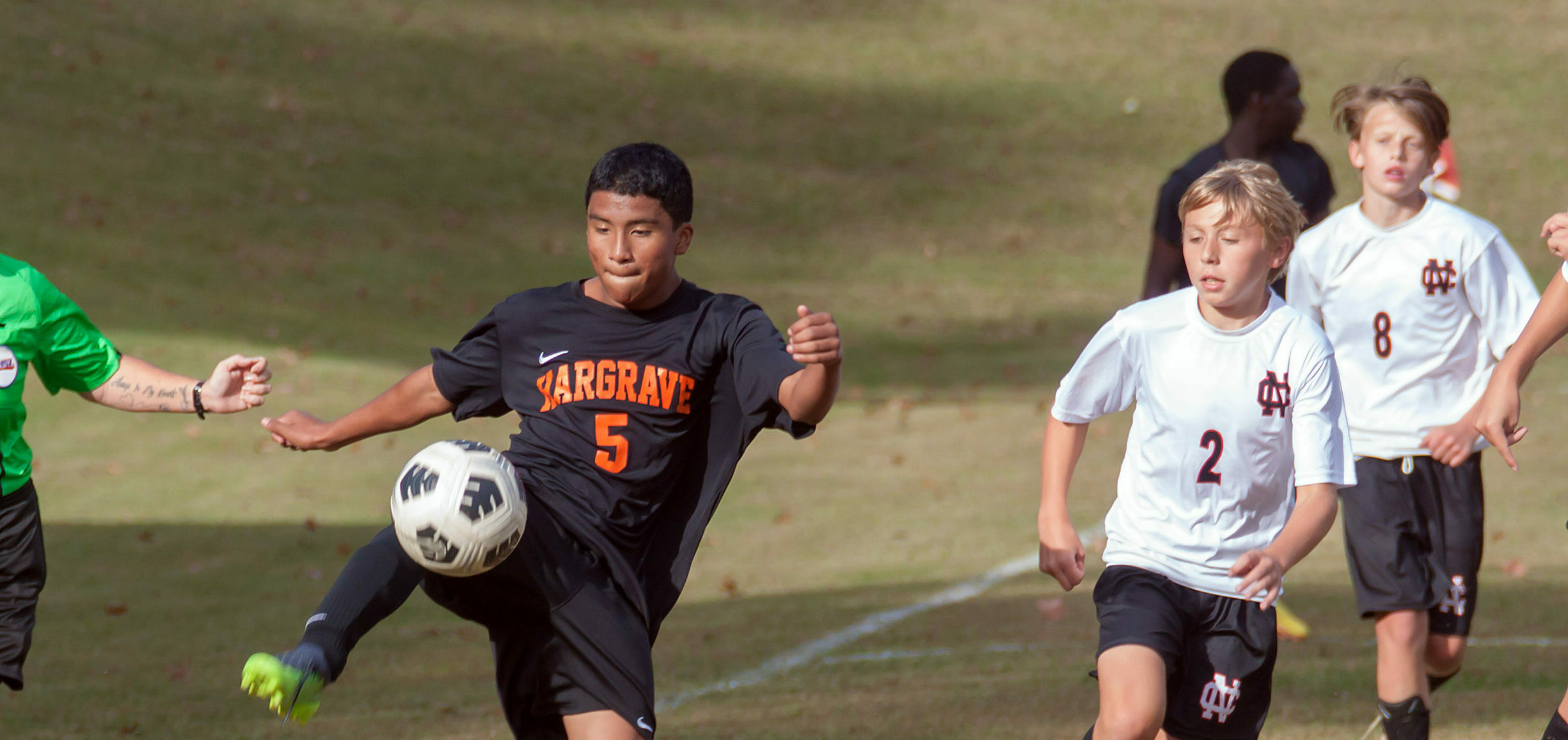 Soccer player kicking ball.
