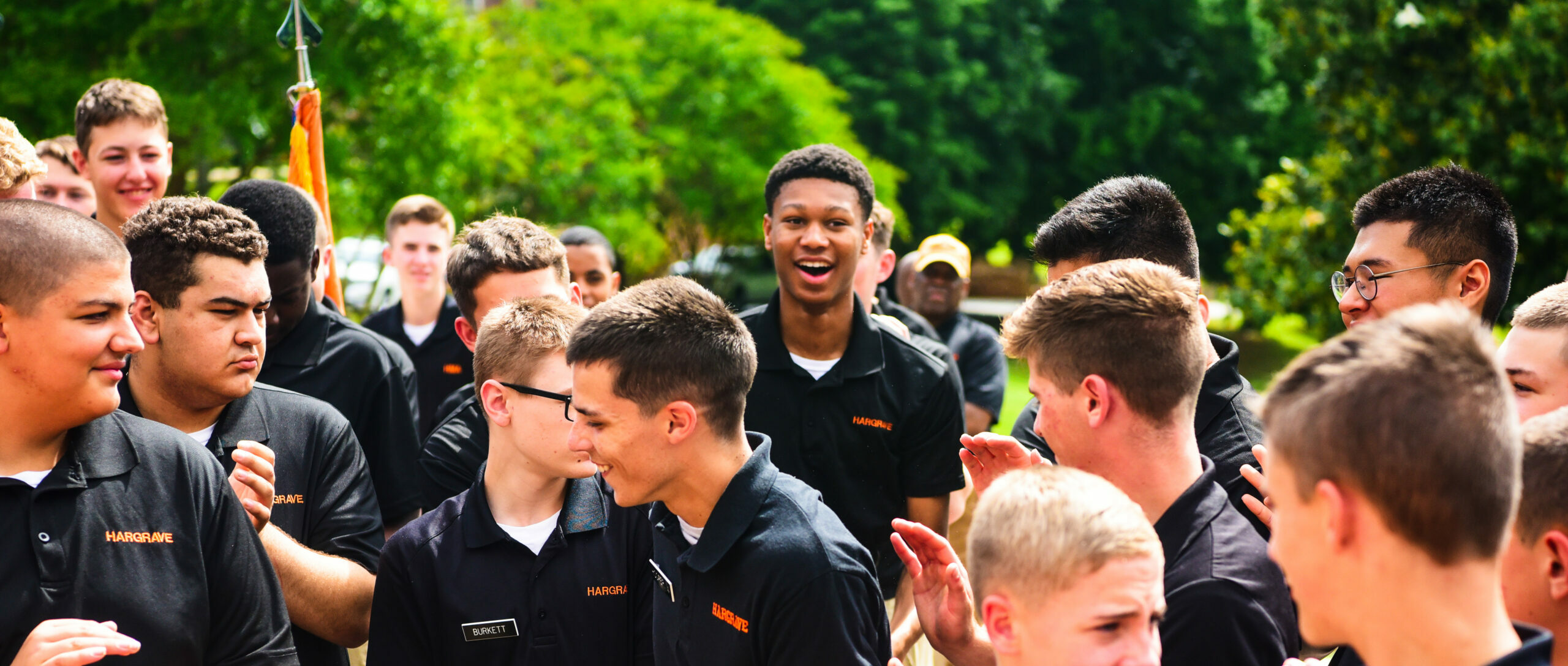 Large group of cadets clapping and laughing.