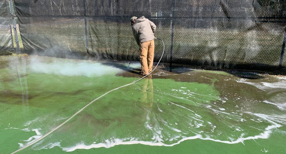 Pressure washing the tennis courts